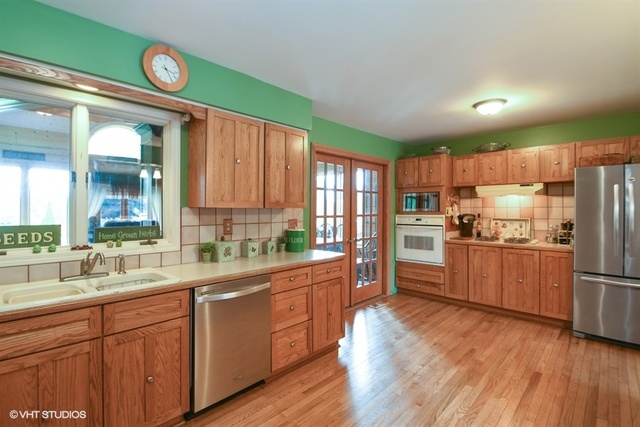25125 South Rondorey Road Elwood, IL 60421 - Photo 11 of 45 a kitchen with a refrigerator a sink and wooden cabinets
