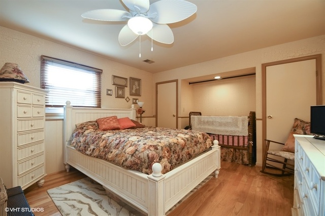 25125 South Rondorey Road Elwood, IL 60421 - Photo 19 of 45 a bed room with a bed and a chandelier