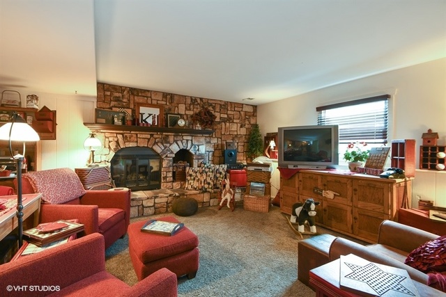 25125 South Rondorey Road Elwood, IL 60421 - Photo 22 of 45 a living room with furniture a fireplace and a flat screen tv