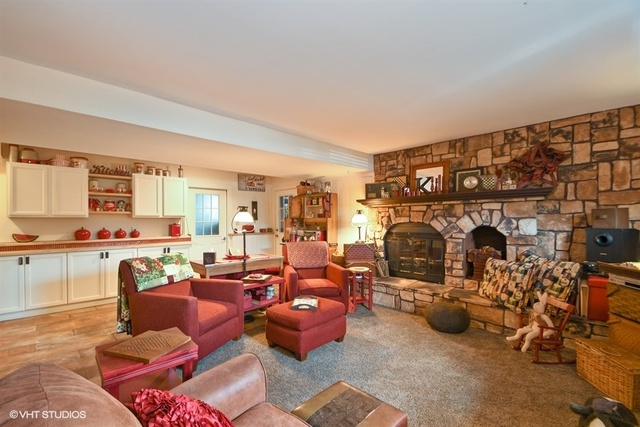 25125 South Rondorey Road Elwood, IL 60421 - Photo 23 of 45 a living room with furniture a rug and a fireplace