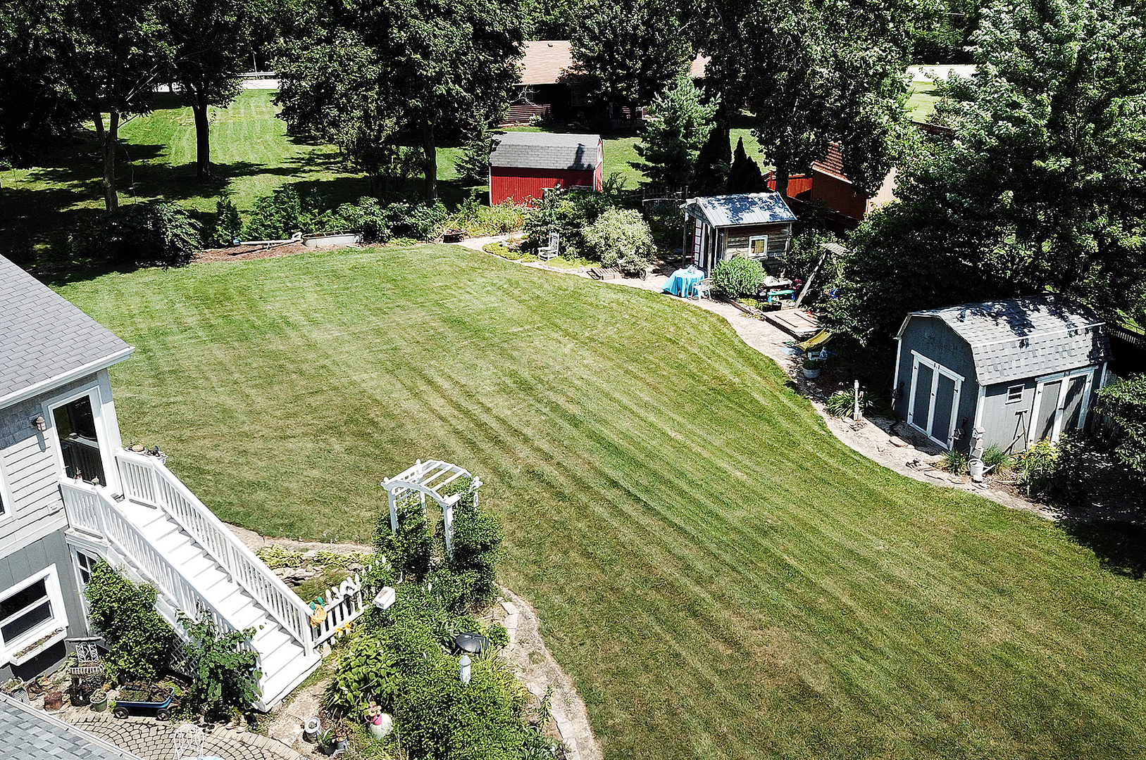 25125 South Rondorey Road Elwood, IL 60421 - Photo 45 of 45 a view of a swimming pool with two chairs in a patio