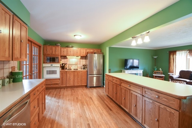 25125 South Rondorey Road Elwood, IL 60421 - Photo 9 of 45 a kitchen with stainless steel appliances wooden floor sink and wooden cabinets