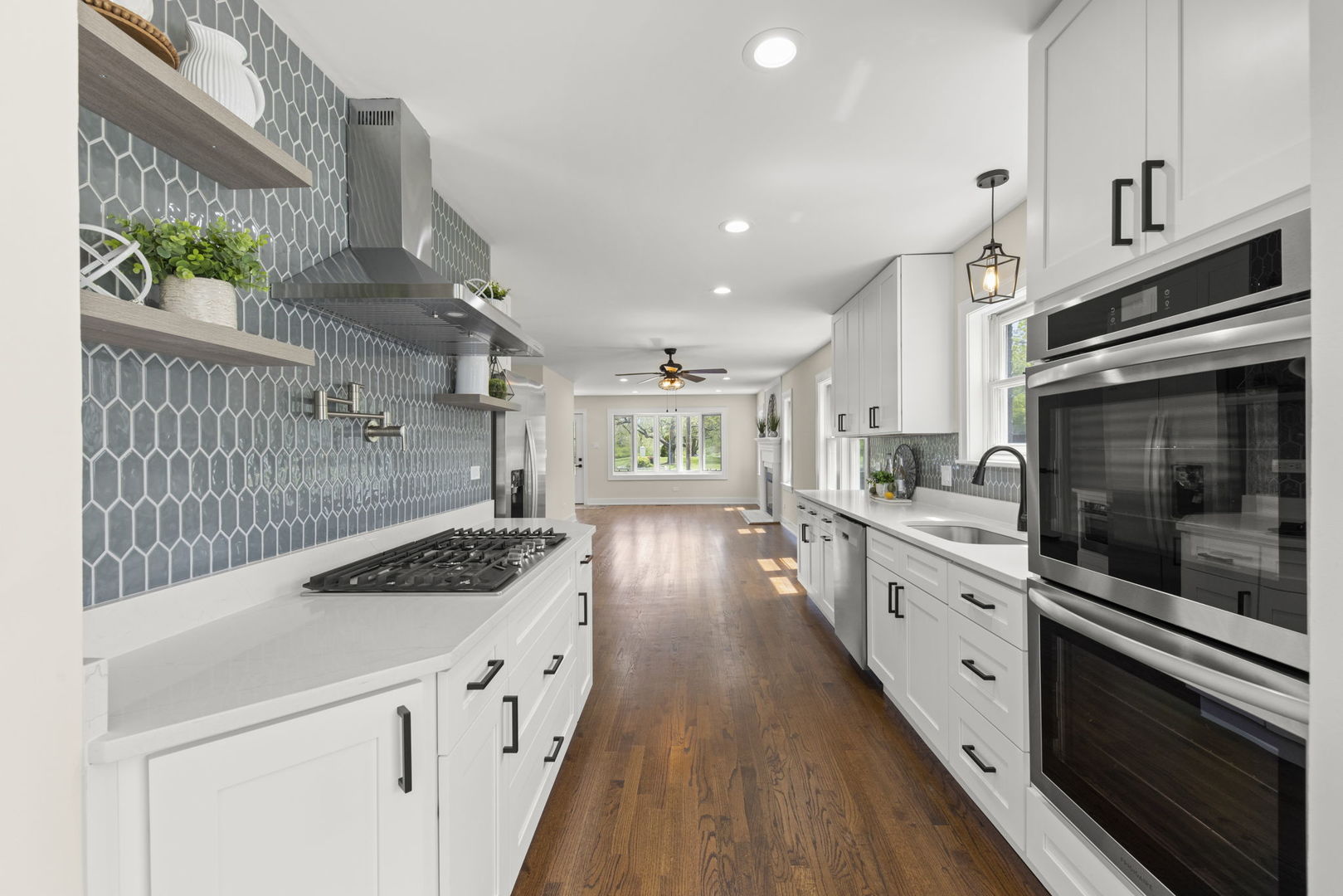 5706 Wolf Road Western Springs, IL 60558 - Photo 12 of 42 a kitchen with stainless steel appliances kitchen island granite countertop a stove a sink and a microwave