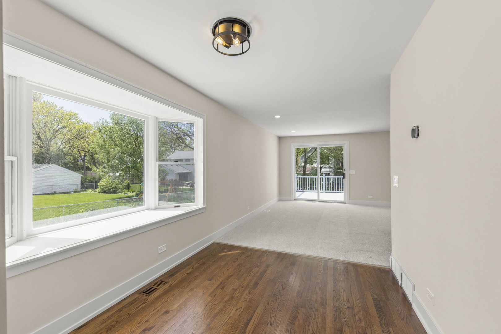 5706 Wolf Road Western Springs, IL 60558 - Photo 13 of 42 an empty room with wooden floor and windows