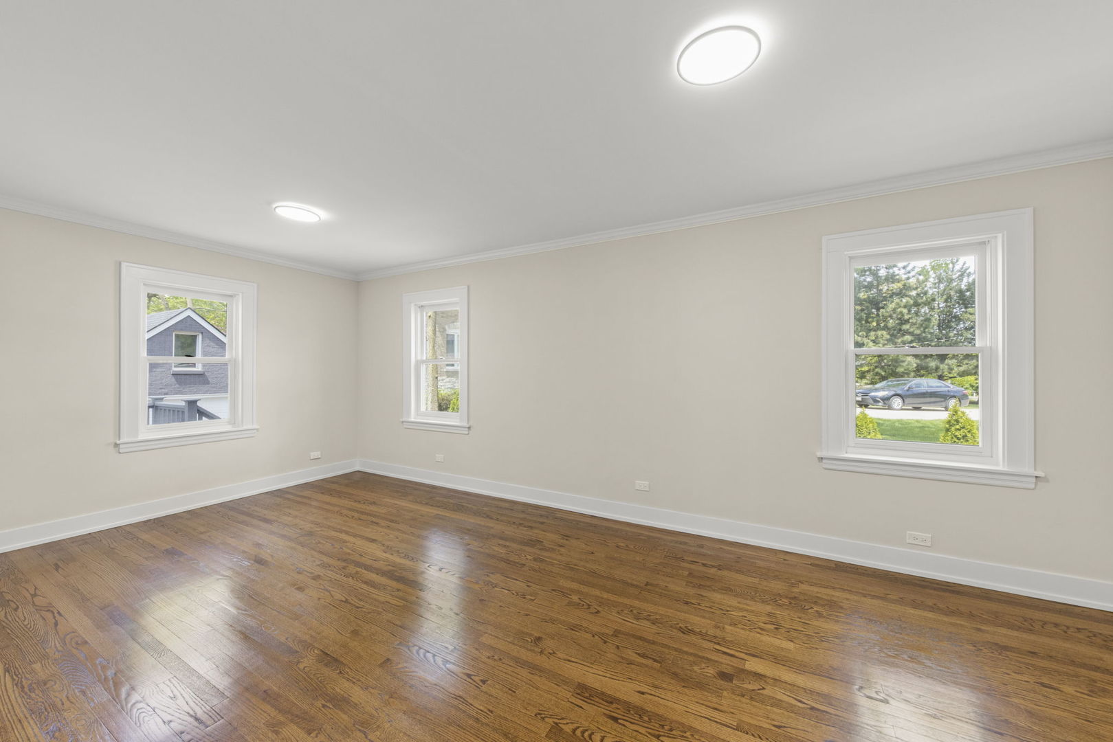 5706 Wolf Road Western Springs, IL 60558 - Photo 17 of 42 a view of an empty room with window and wooden floor