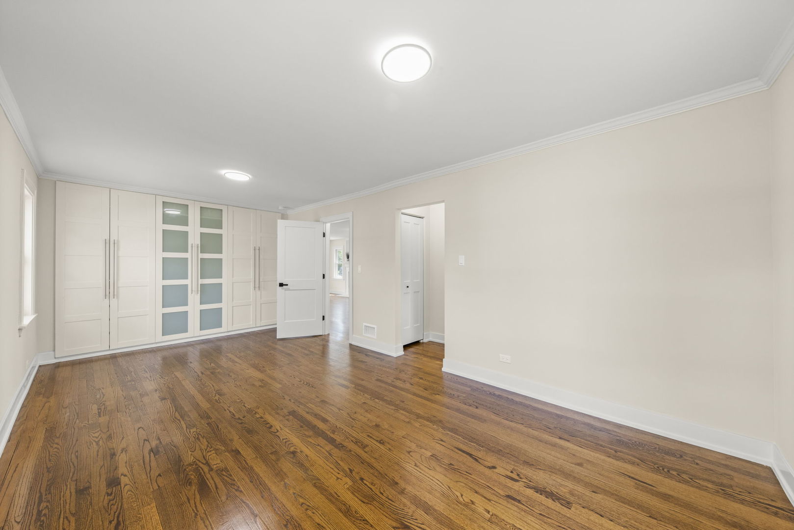 5706 Wolf Road Western Springs, IL 60558 - Photo 18 of 42 a view of an empty room with wooden floor and a window