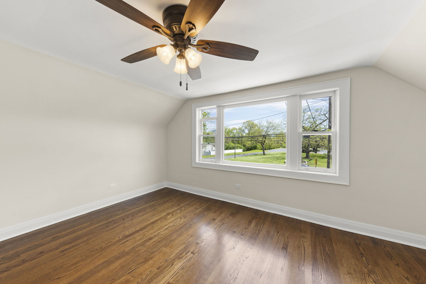 5706 Wolf Road Western Springs, IL 60558 - Photo 20 of 42 a view of an empty room with wooden floor and a window