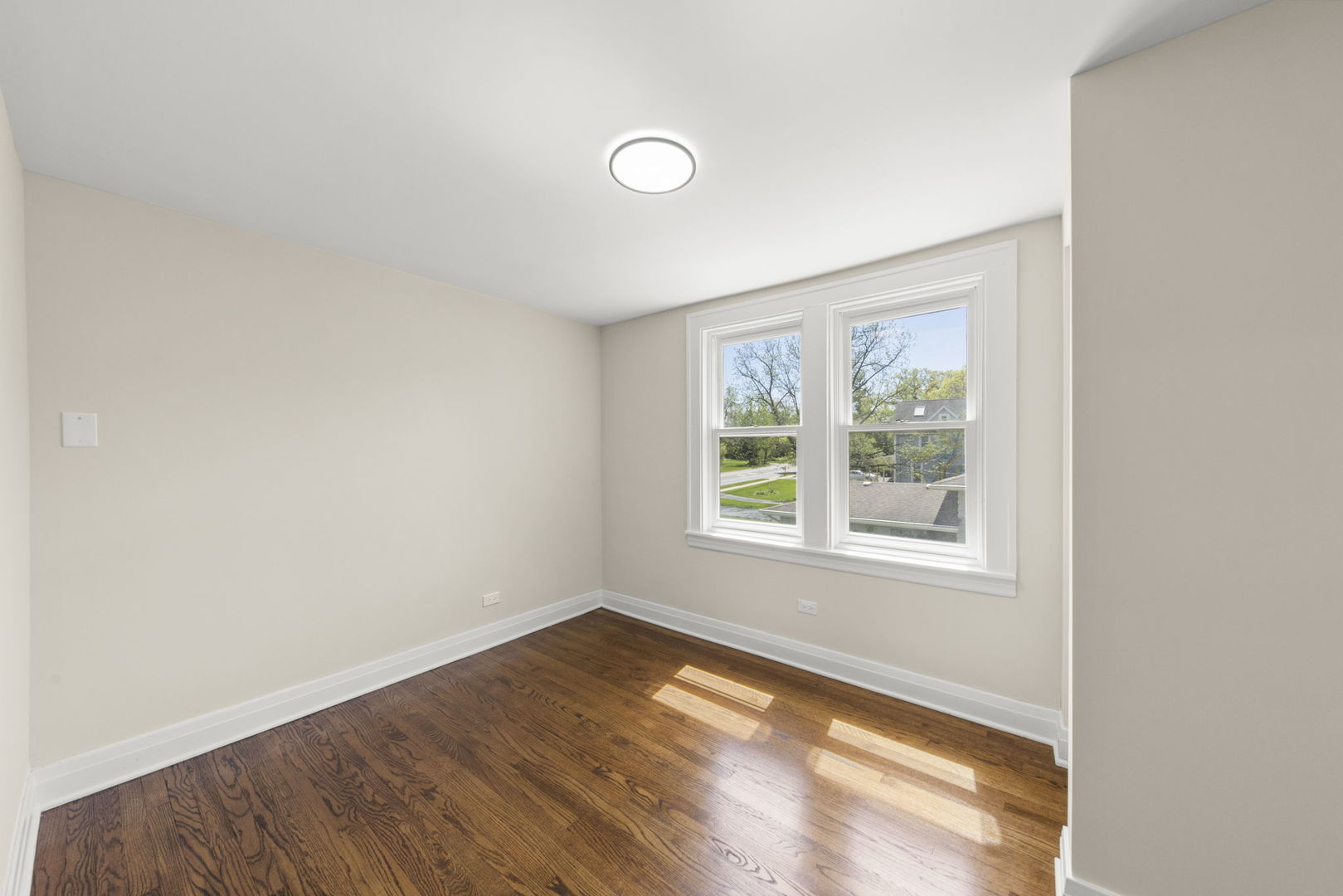 5706 Wolf Road Western Springs, IL 60558 - Photo 22 of 42 an empty room with wooden floor and windows