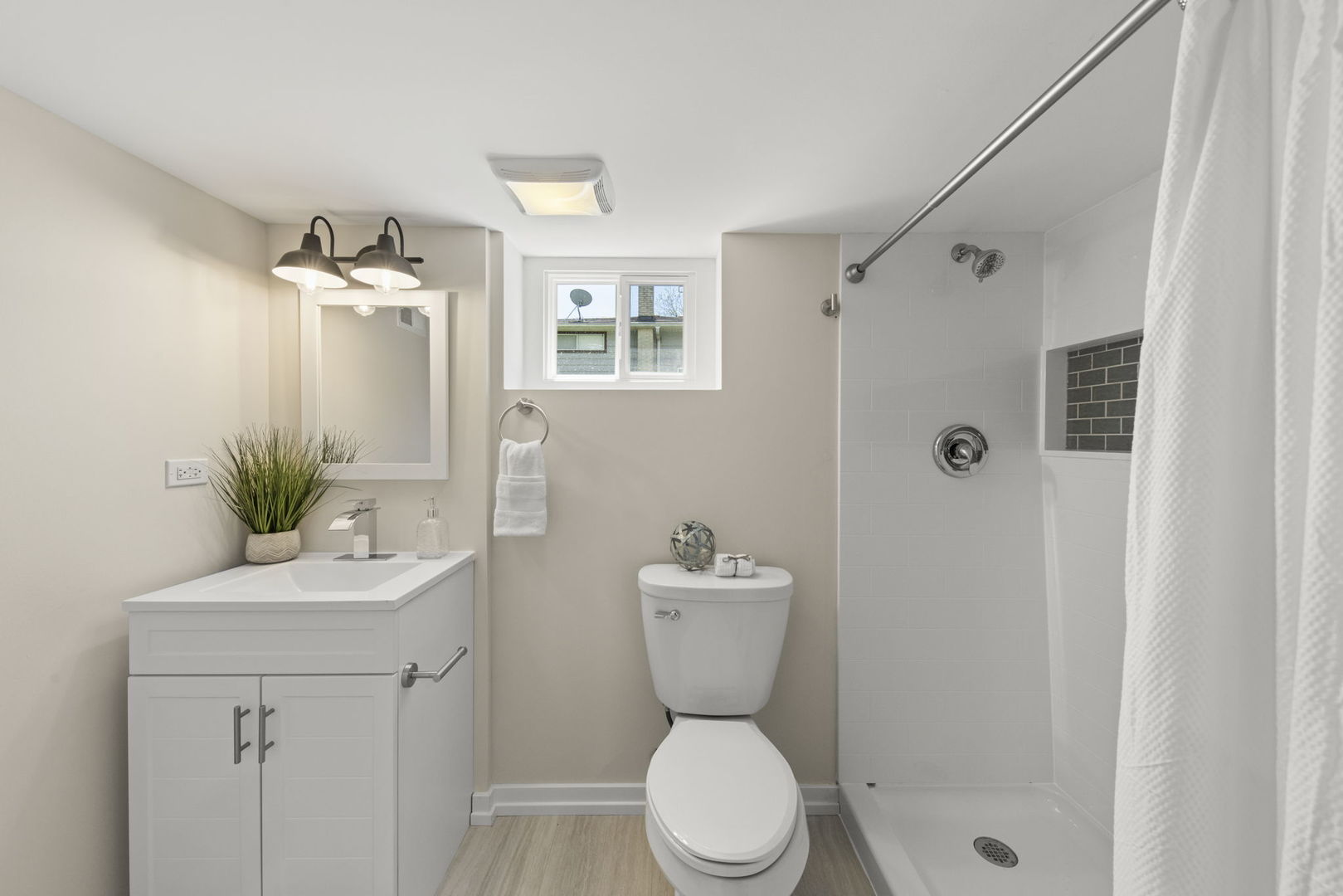 5706 Wolf Road Western Springs, IL 60558 - Photo 33 of 42 a bathroom with a toilet a sink and shower