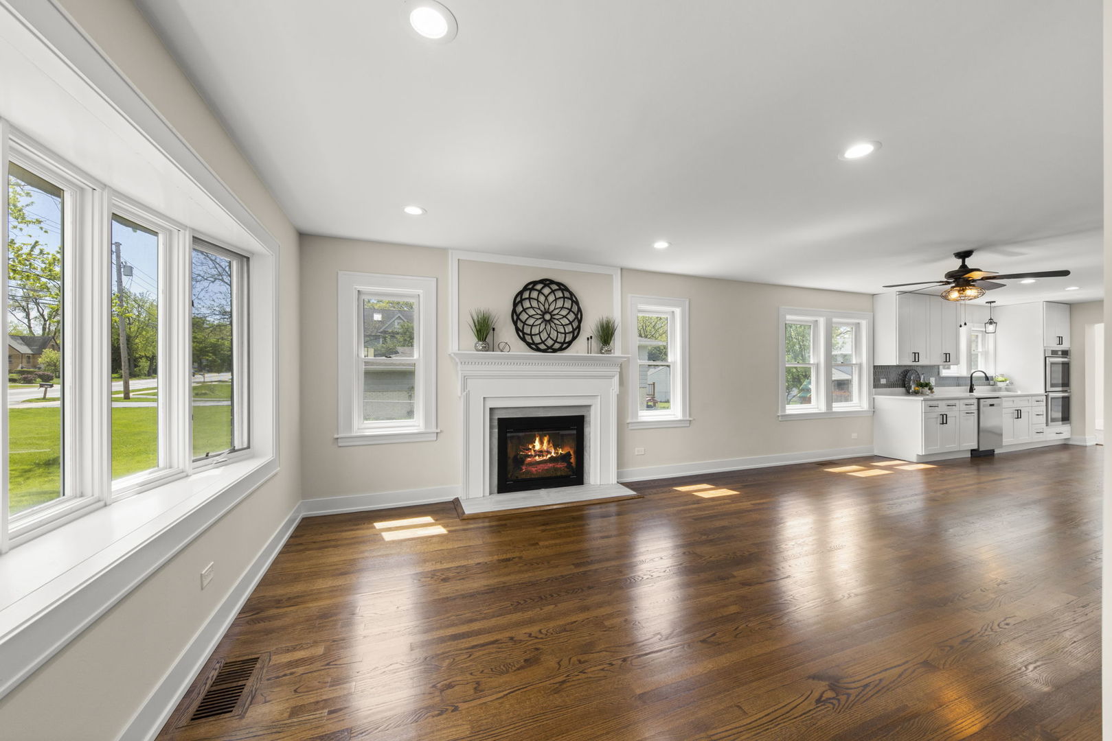 5706 Wolf Road Western Springs, IL 60558 - Photo 5 of 42 a view of an empty room with wooden floor fireplace and a window