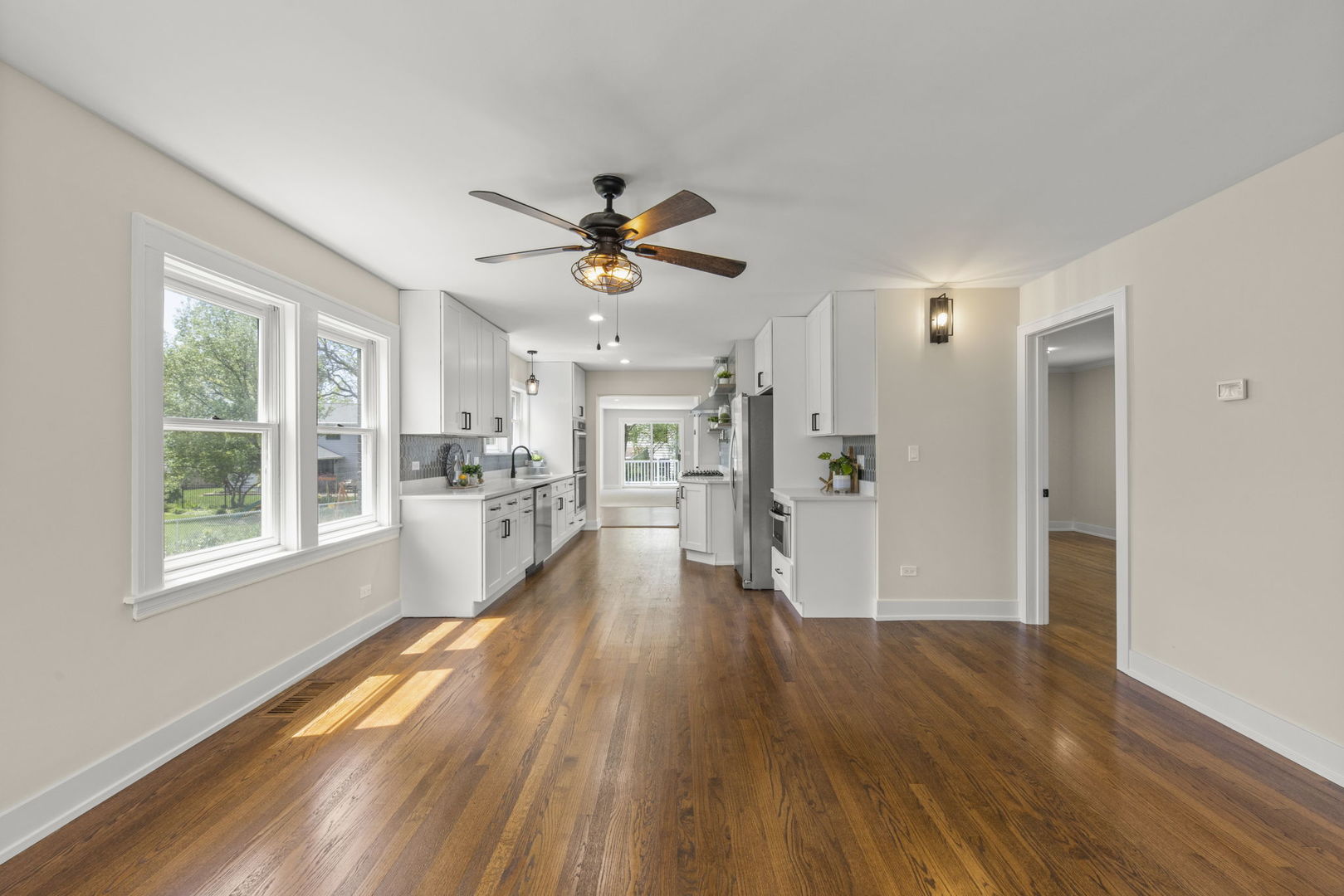 5706 Wolf Road Western Springs, IL 60558 - Photo 7 of 42 a view of a living room with wooden floor and a ceiling fan