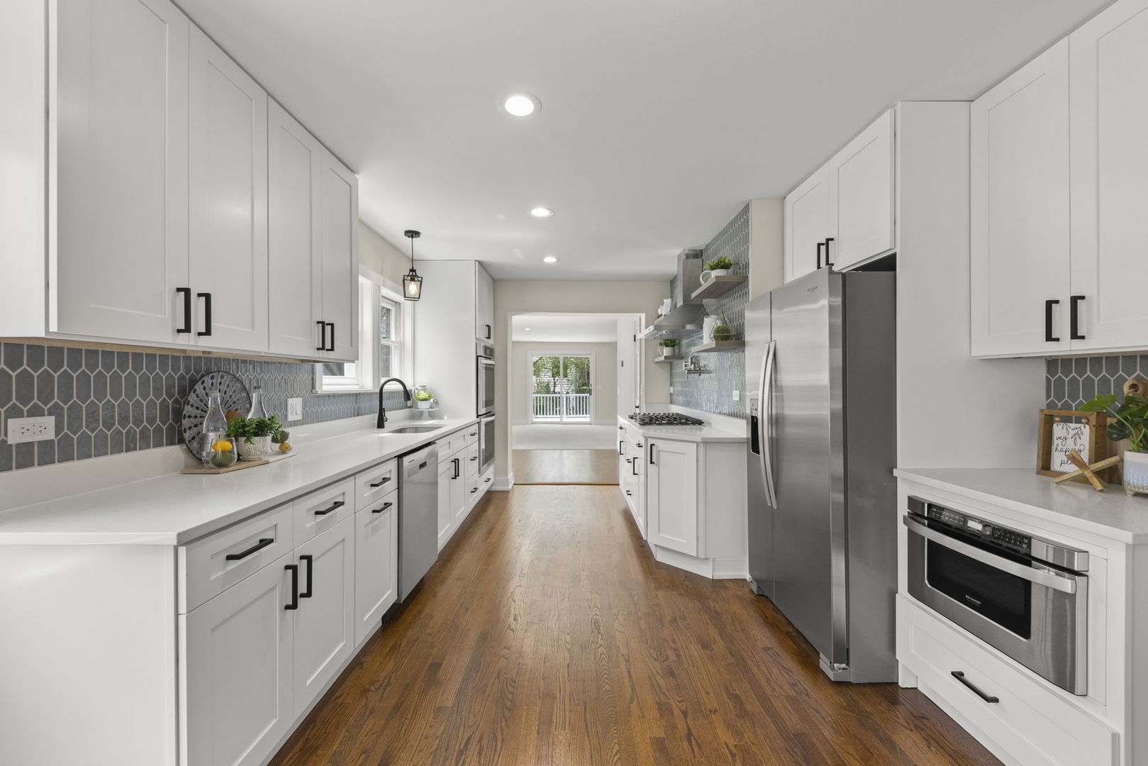 5706 Wolf Road Western Springs, IL 60558 - Photo 9 of 42 a kitchen with a refrigerator a sink and wooden floor