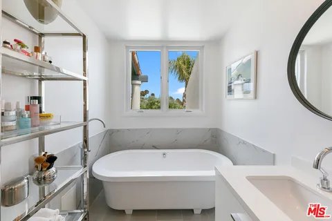 a white bath tub sitting next to a window