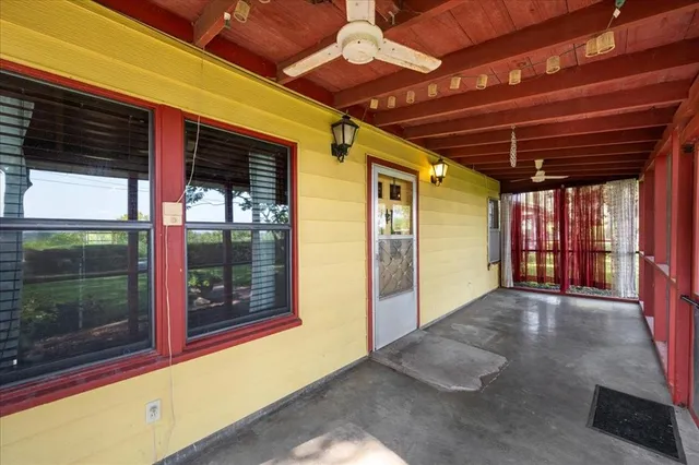 a view of porch with a table and chairs