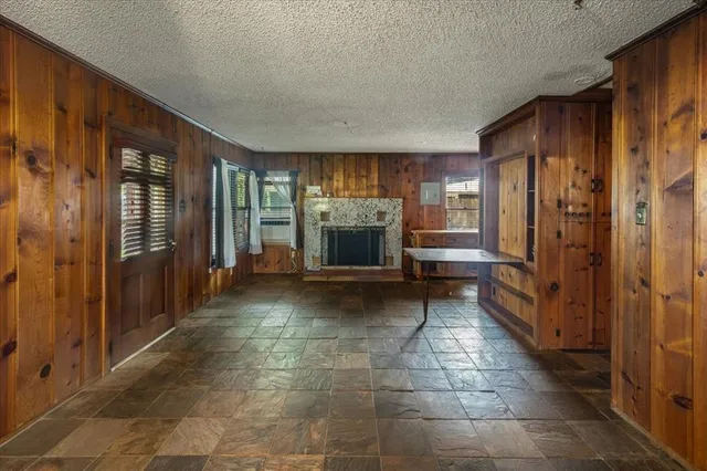 a view of a hallway with stairs and furniture