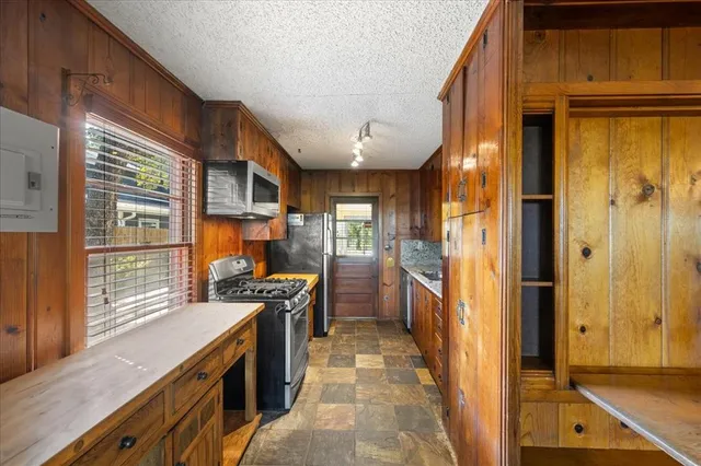 a kitchen with stainless steel appliances granite countertop a stove and a refrigerator