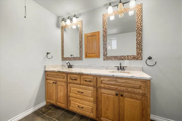 a bathroom with a sink double vanity and a mirror