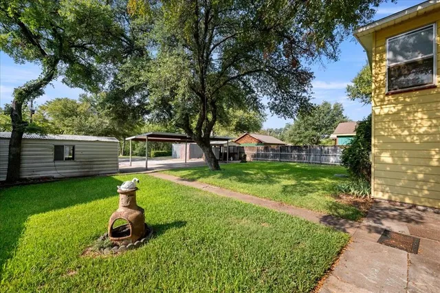 a house with green field in front of it