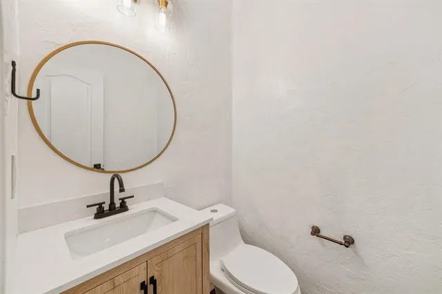 a bathroom with a sink a mirror and a toilet