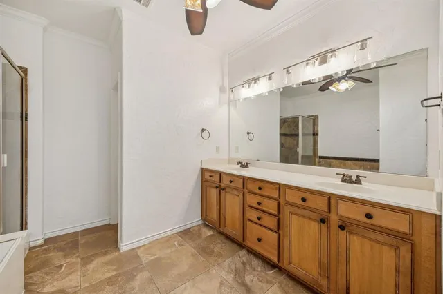 a spacious bathroom with a double vanity sink a mirror and shower