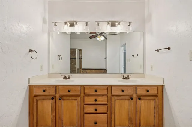 a bathroom with a sink vanity and a mirror