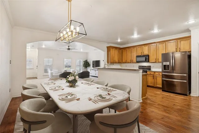 a view of a dining room with furniture kitchen and wooden floor