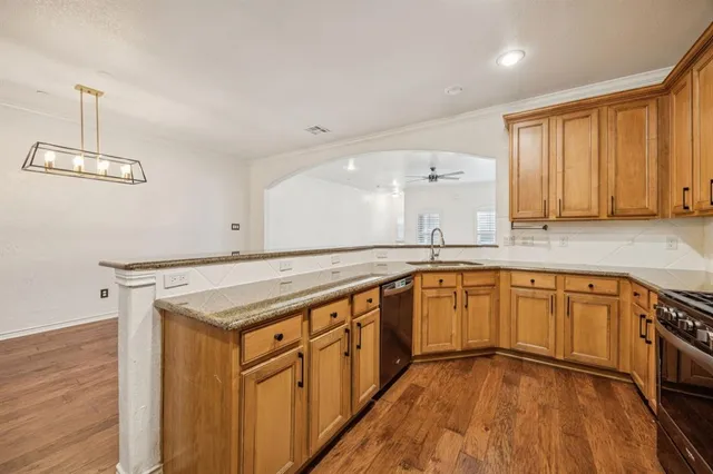 a kitchen with stainless steel appliances granite countertop a sink stove and cabinets