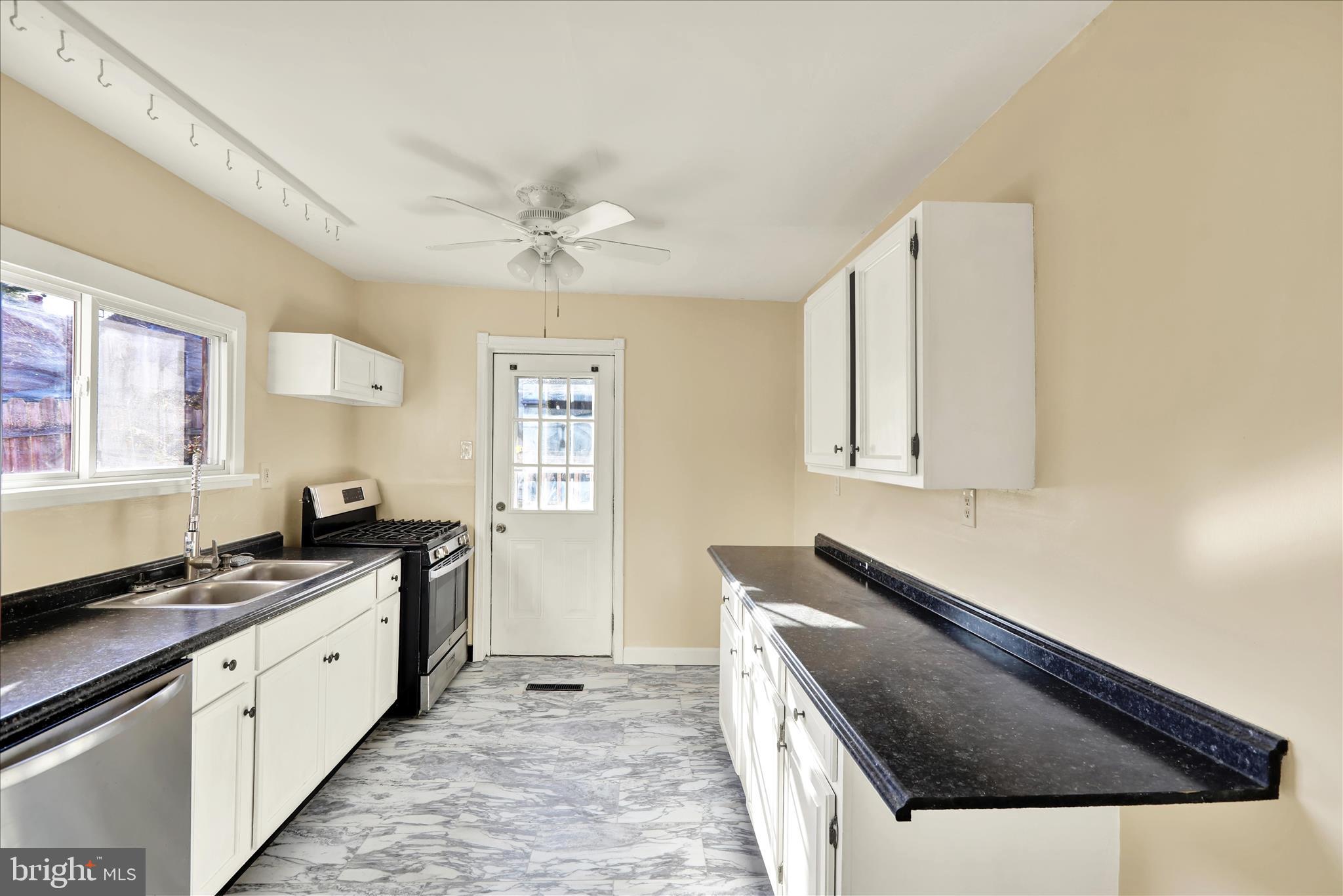 832 Houston Street Columbia, PA 17512 - Photo 20 of 24 a kitchen with stainless steel appliances a sink a stove and a window