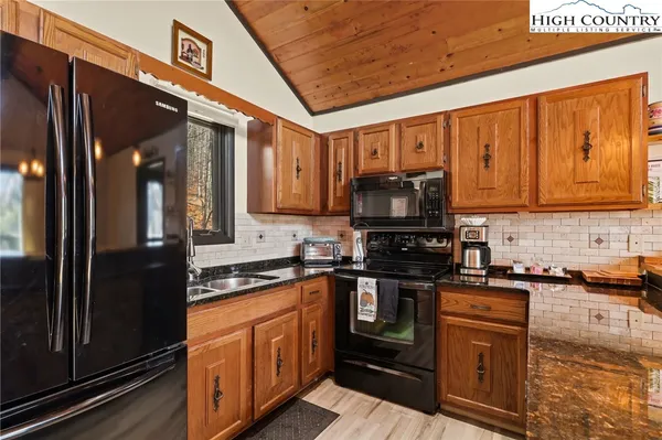 a living room with furniture a window and a flat screen tv