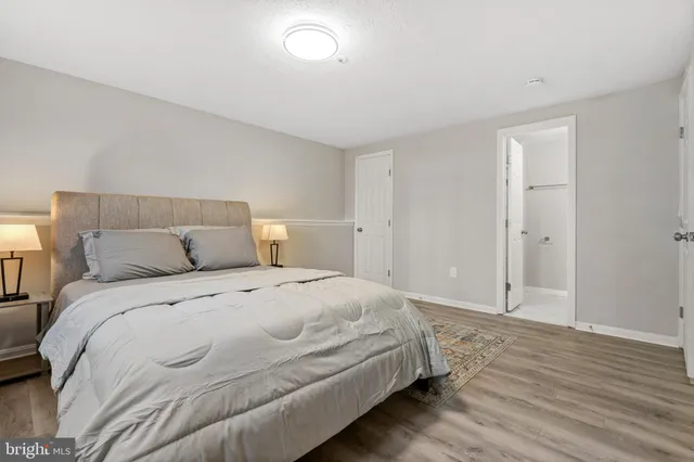 a large bed sitting in a bedroom and wooden floor