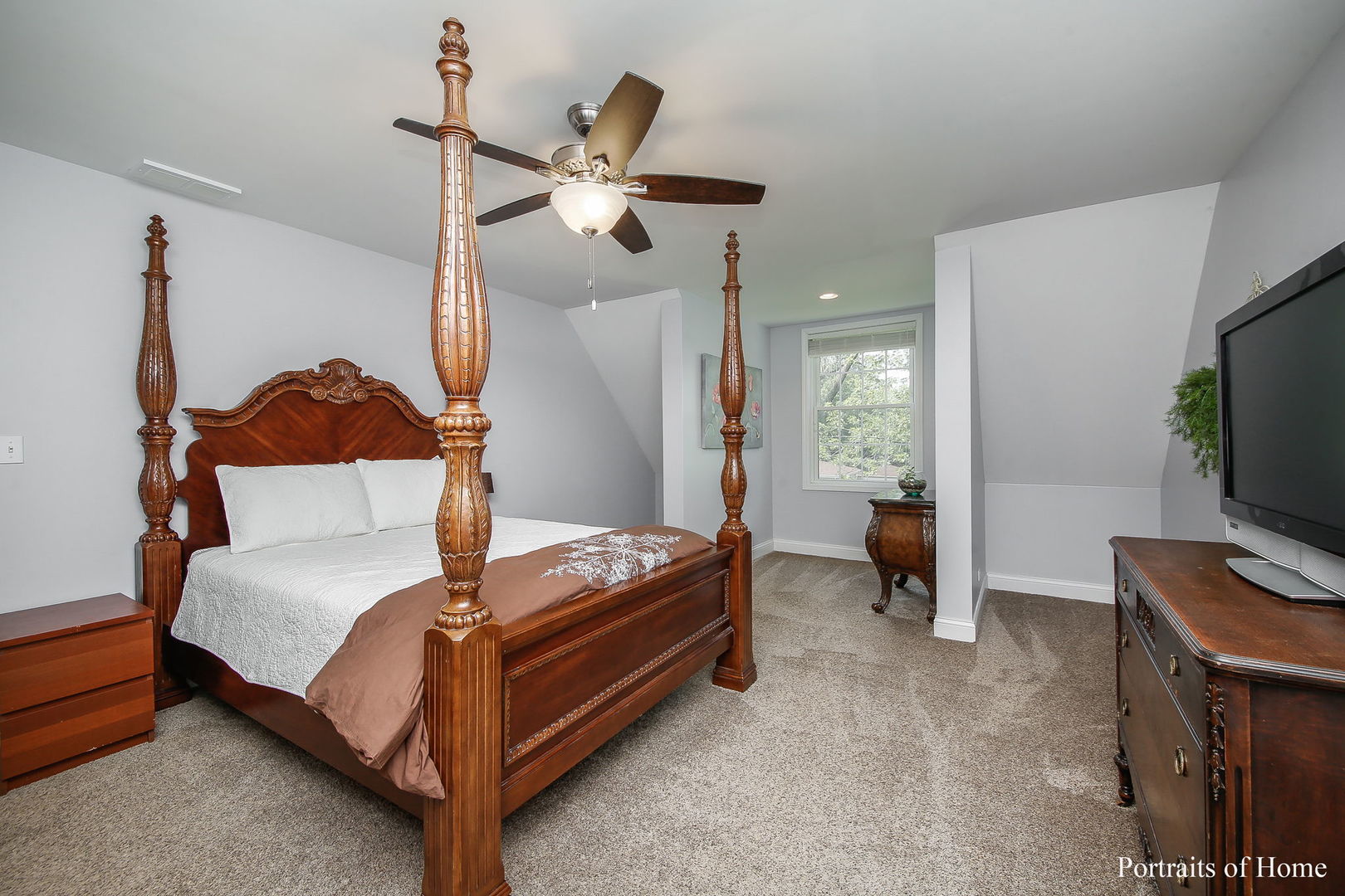 231 Highland Road Willowbrook, IL 60527 - Photo 13 of 38 a bedroom with a bed and a flat tv screen on dresser