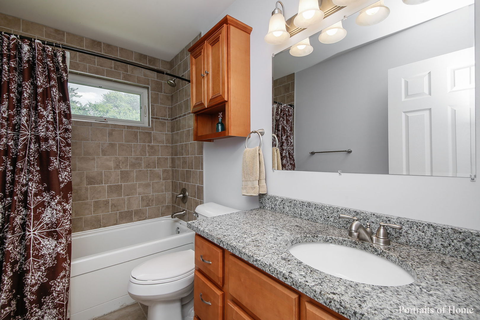 231 Highland Road Willowbrook, IL 60527 - Photo 17 of 38 a bathroom with a granite countertop sink a toilet a mirror a bathtub and shower