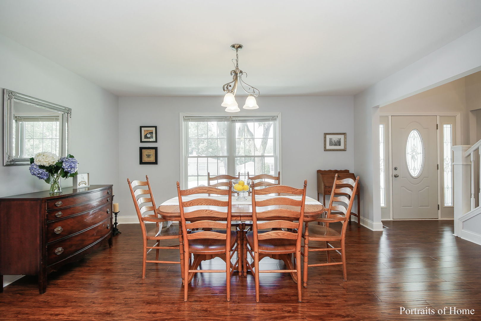 231 Highland Road Willowbrook, IL 60527 - Photo 10 of 38 a dining room with wooden floor a chandelier a glass table and chairs