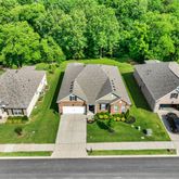 an aerial view of multiple houses with a yard