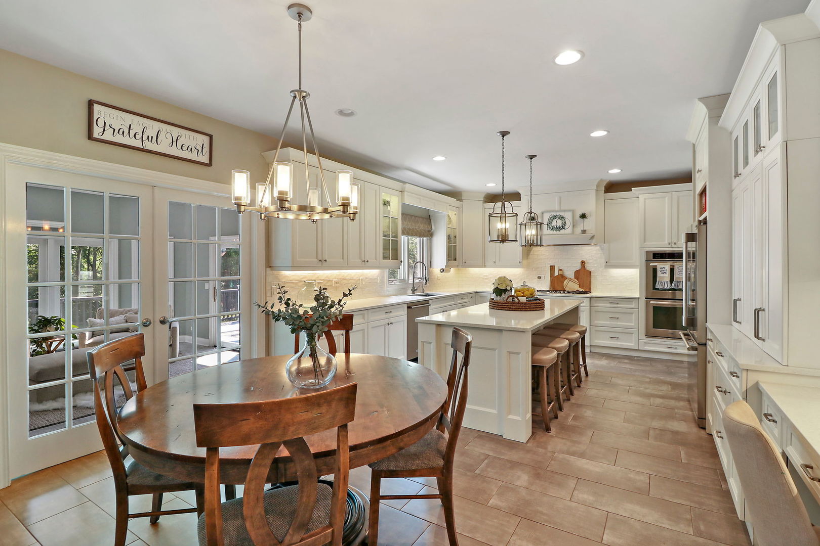 31 Overbrook Road South Barrington, IL 60010 - Photo 8 of 65 a dining room with stainless steel appliances kitchen island a table and chairs