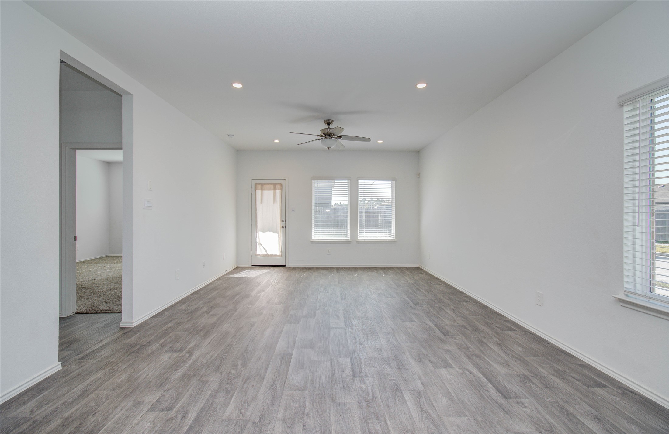 5402 Creekstone Rise Lane Spring, TX 77373 - Photo 7 of 22 Natural light floods this open-concept living area, highlighting the vinyl plank floors