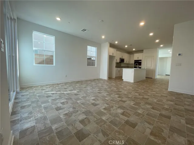 a view of a kitchen with a sink and white cabinets
