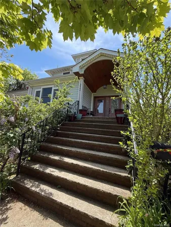 a front view of a house with a garden
