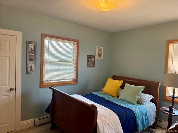 a bed sitting in a bedroom next to a window