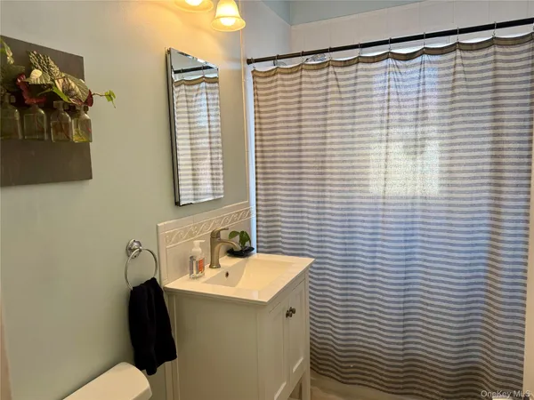 a bathroom with a sink and a shower curtain