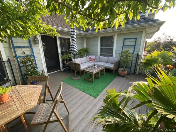 a view of a house with backyard and sitting area