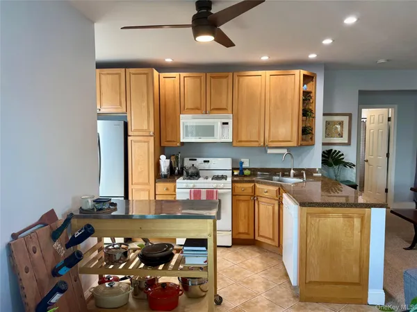 a kitchen with stainless steel appliances granite countertop a stove refrigerator sink and cabinets