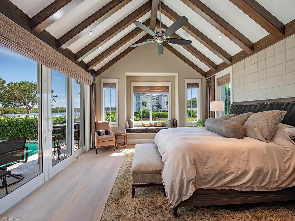 1482 2nd Avenue South Naples, FL 34102 - Photo 11 of 25 a bed sitting in a bedroom next to a large window