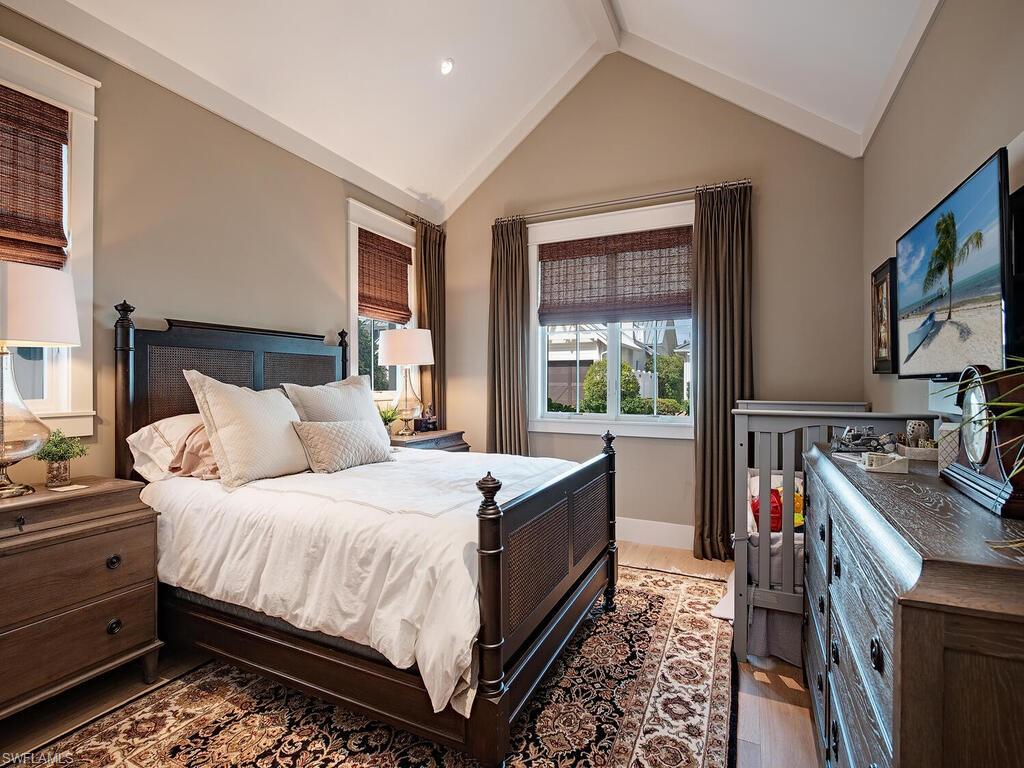 1482 2nd Avenue South Naples, FL 34102 - Photo 13 of 25 a bed room with a bed and a flat tv screen