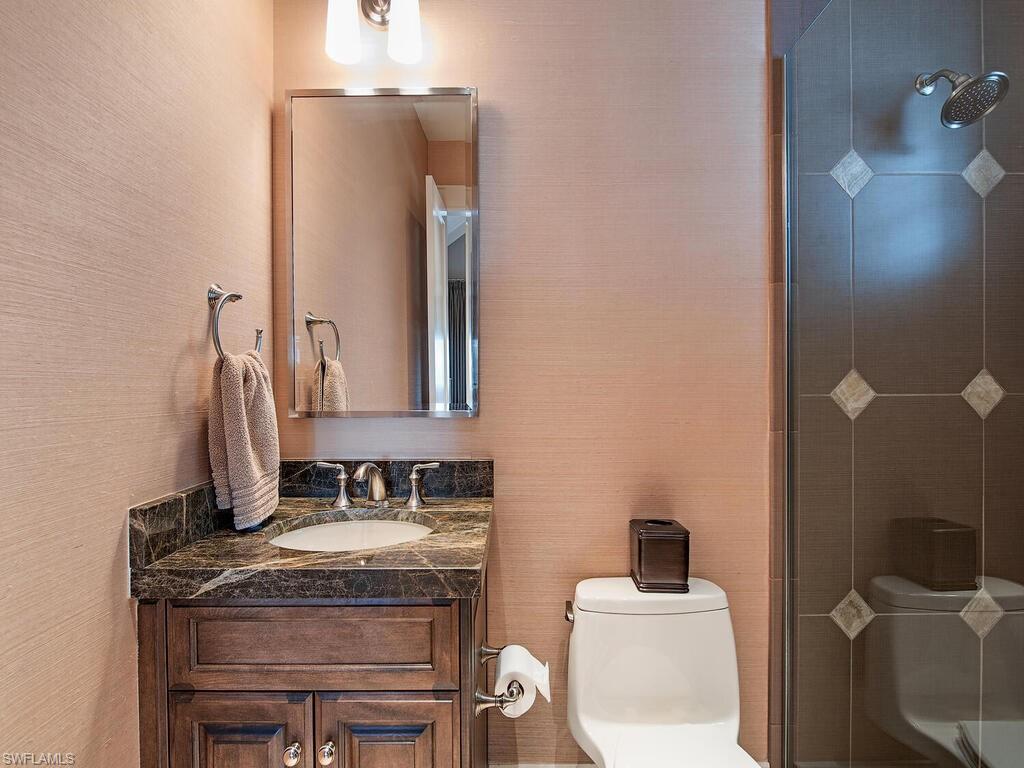 1482 2nd Avenue South Naples, FL 34102 - Photo 14 of 25 a bathroom with a granite countertop sink and a mirror