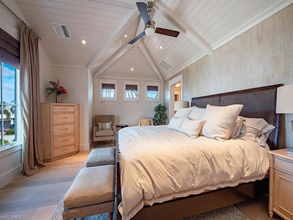 1482 2nd Avenue South Naples, FL 34102 - Photo 15 of 25 a spacious bedroom with a bed a dresser and wooden floor