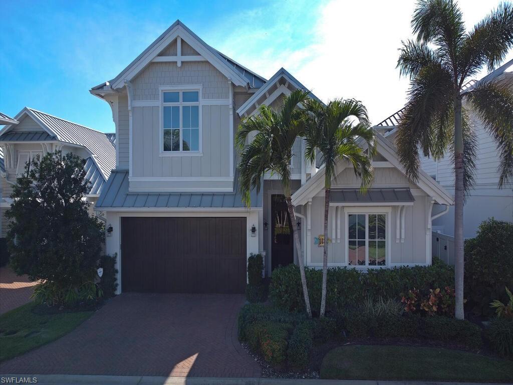 1482 2nd Avenue South Naples, FL 34102 - Photo 20 of 25 a front view of a house with a garden