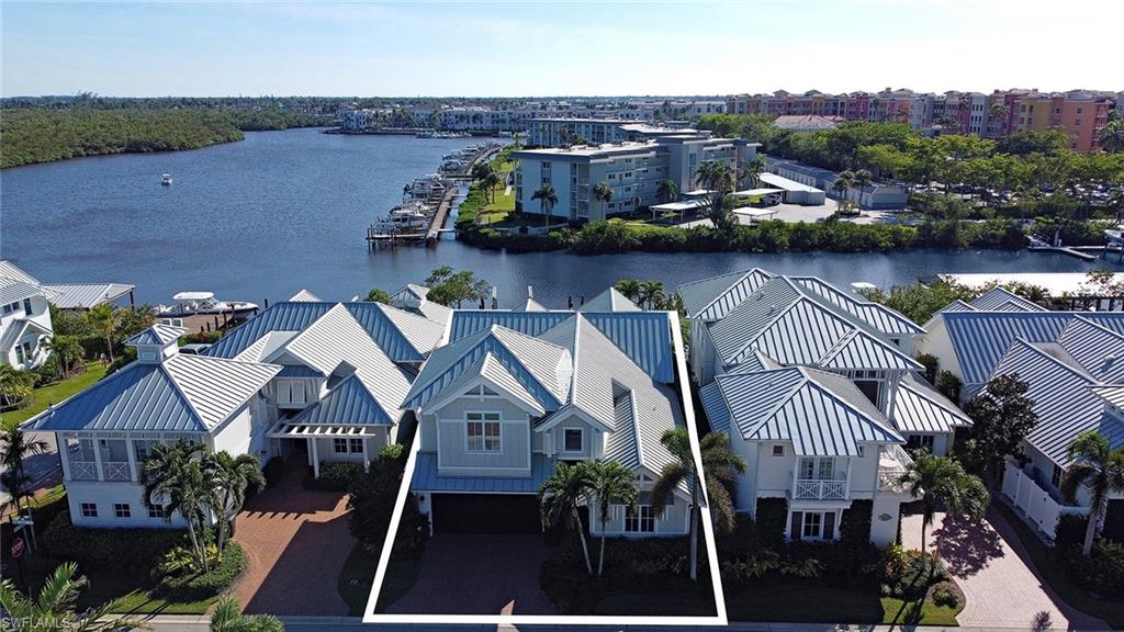 1482 2nd Avenue South Naples, FL 34102 - Photo 22 of 25 an aerial view of a house with a lake and a mountain view