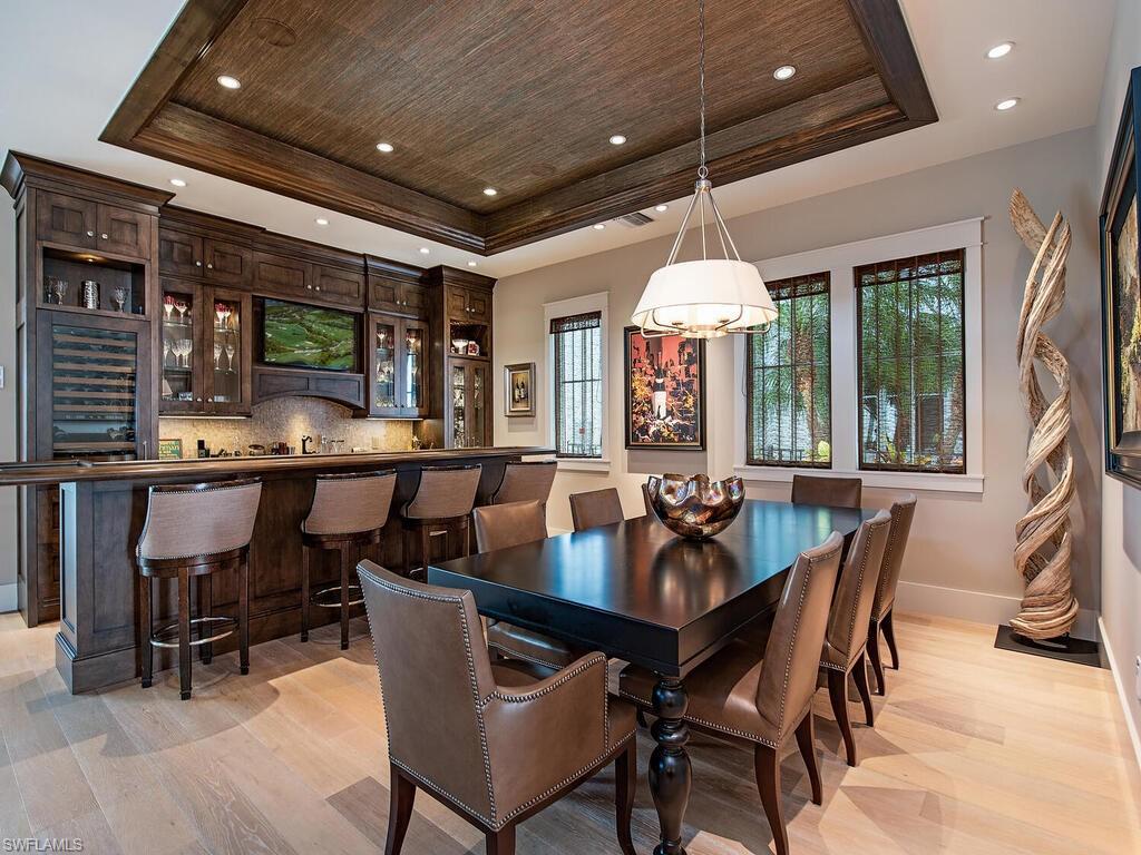 1482 2nd Avenue South Naples, FL 34102 - Photo 5 of 25 a dining room with furniture a rug and a chandelier