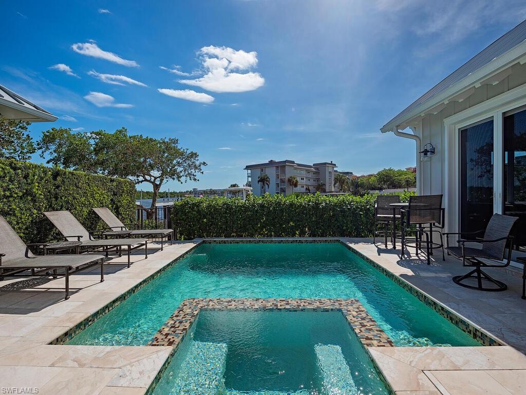 1482 2nd Avenue South Naples, FL 34102 - Photo 10 of 25 a view of a swimming pool with a patio